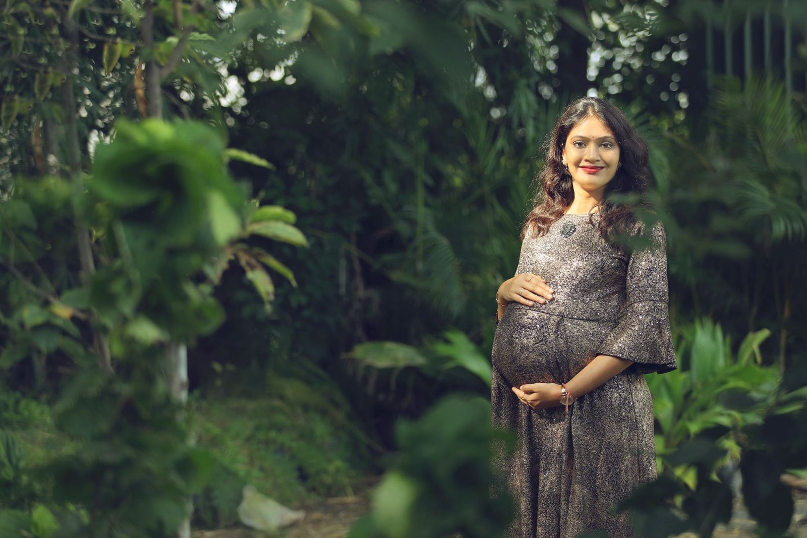 Smiling pregnant woman in a garden